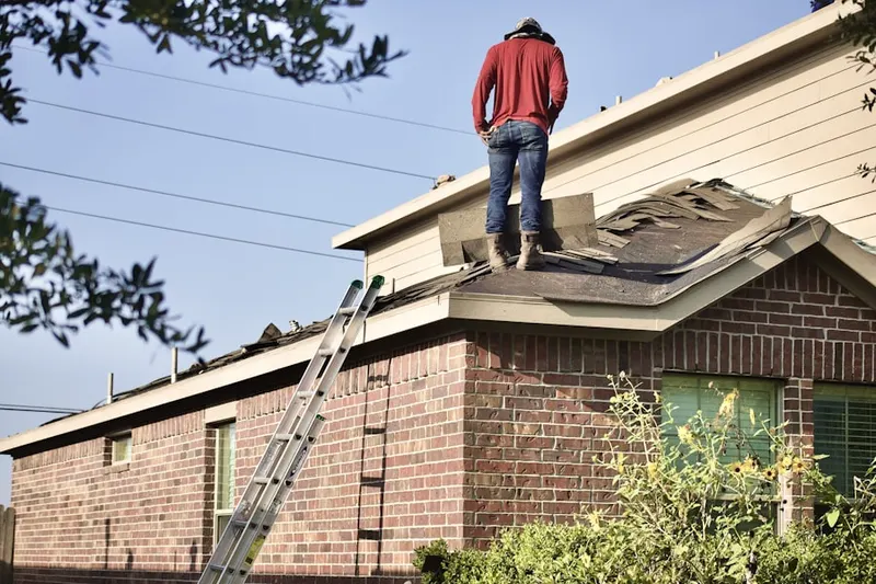 Professional roofer working on a residential roof in Deer Island